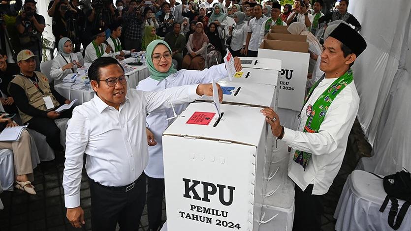 Cawapres nomor urut 1 Muhaimin Iskandar (kiri) bersama istrinya, Rustini Murtadho (kedua kiri) memasukkan surat suara yang telah mereka coblos ke dalam kotak suara di TPS 023 Kelurahan Bangka, Mampang, Jakarta, Rabu (14/2/2024). ANTARA FOTO/Aditya Pradana Putra/tom.